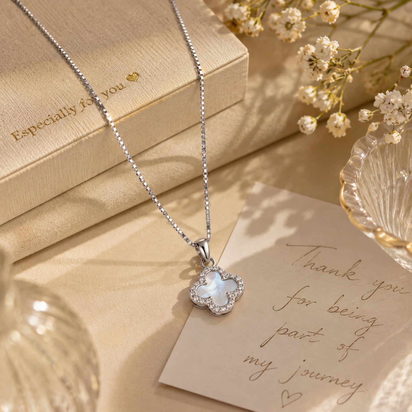 925 sterling silver double-sided four leaf clover necklace with white mother of pearl and sparkling CZ stones, styled as a gift for her.