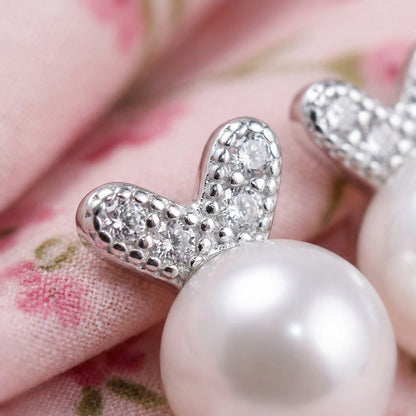 Close-up of 925 sterling silver pearl bunny stud earrings with crystal bunny ears