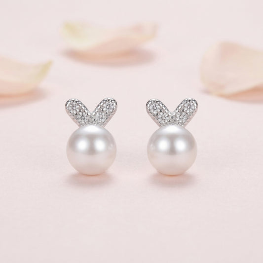 925 sterling silver pearl bunny stud earrings front view on soft pink background