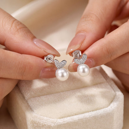 Hand holding 925 sterling silver pearl bunny stud earrings with cute bunny ears and pearl accents for gifting