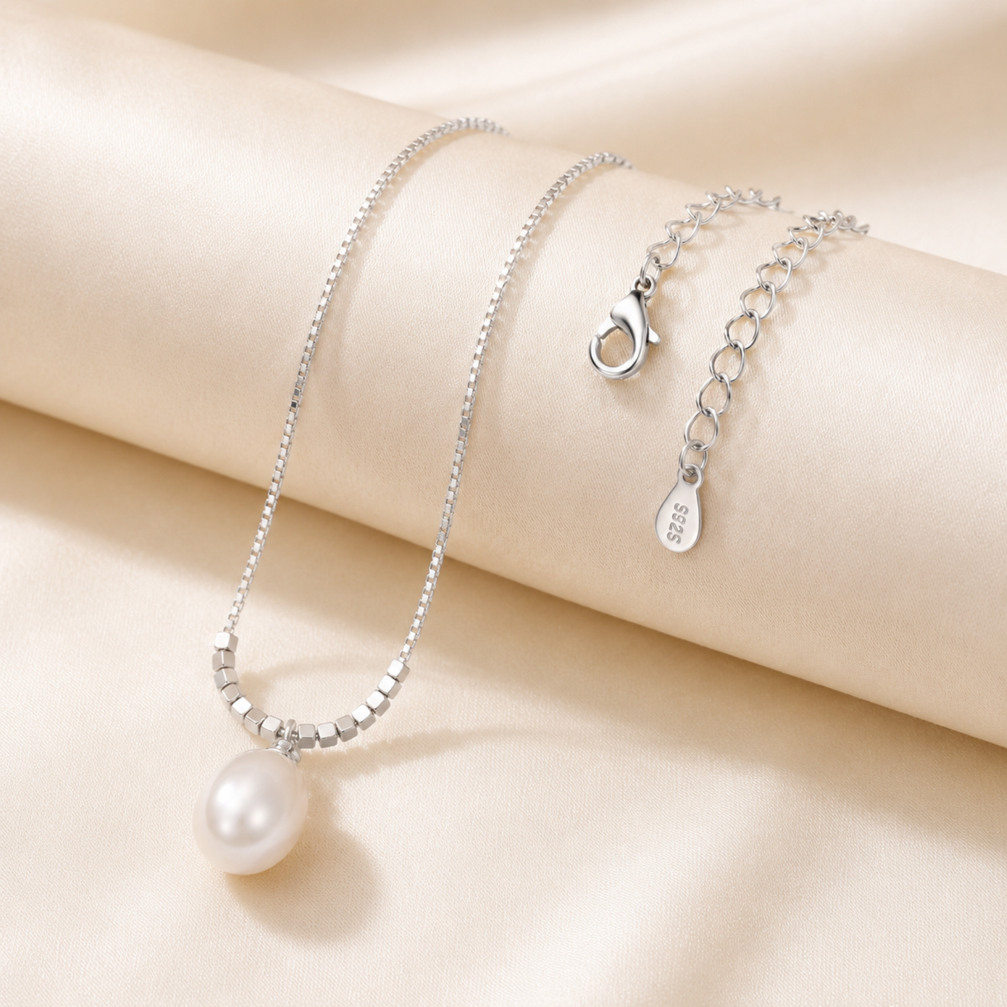 Close up of 925 sterling silver teardrop pearl pendant necklace with delicate chain and tag