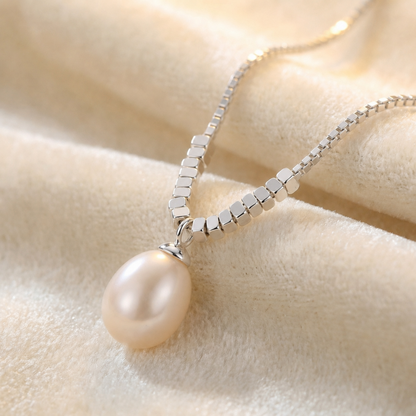 Close up of 925 sterling silver teardrop pearl pendant necklace with delicate chain