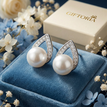 Close-up of 925 sterling silver pearl teardrop stud earrings with sparkling detail