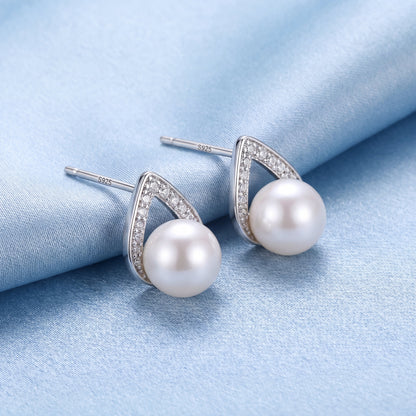 925 sterling silver pearl teardrop stud earrings with polished silver curves and soft white pearls on blue satin