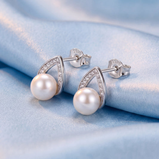 925 sterling silver pearl teardrop stud earrings with white pearls and delicate silver teardrop design on blue satin