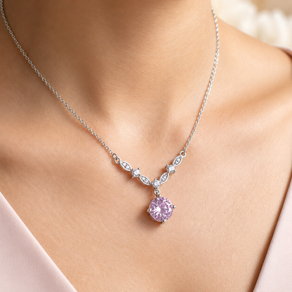 Pink cubic zirconia floral vine necklace styled on model with soft white outfit