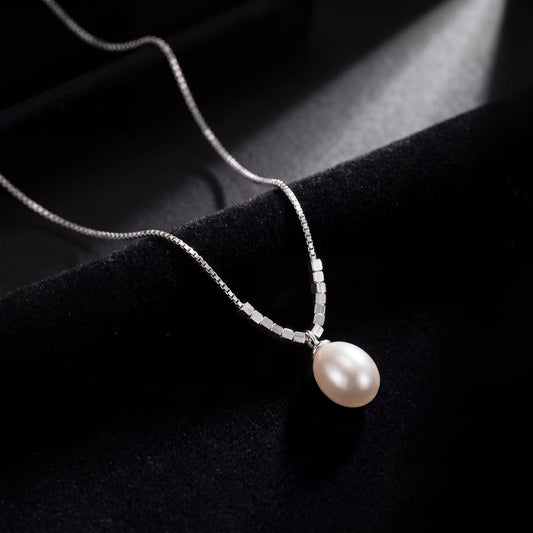 925 sterling silver teardrop pearl pendant necklace photographed on black fabric background