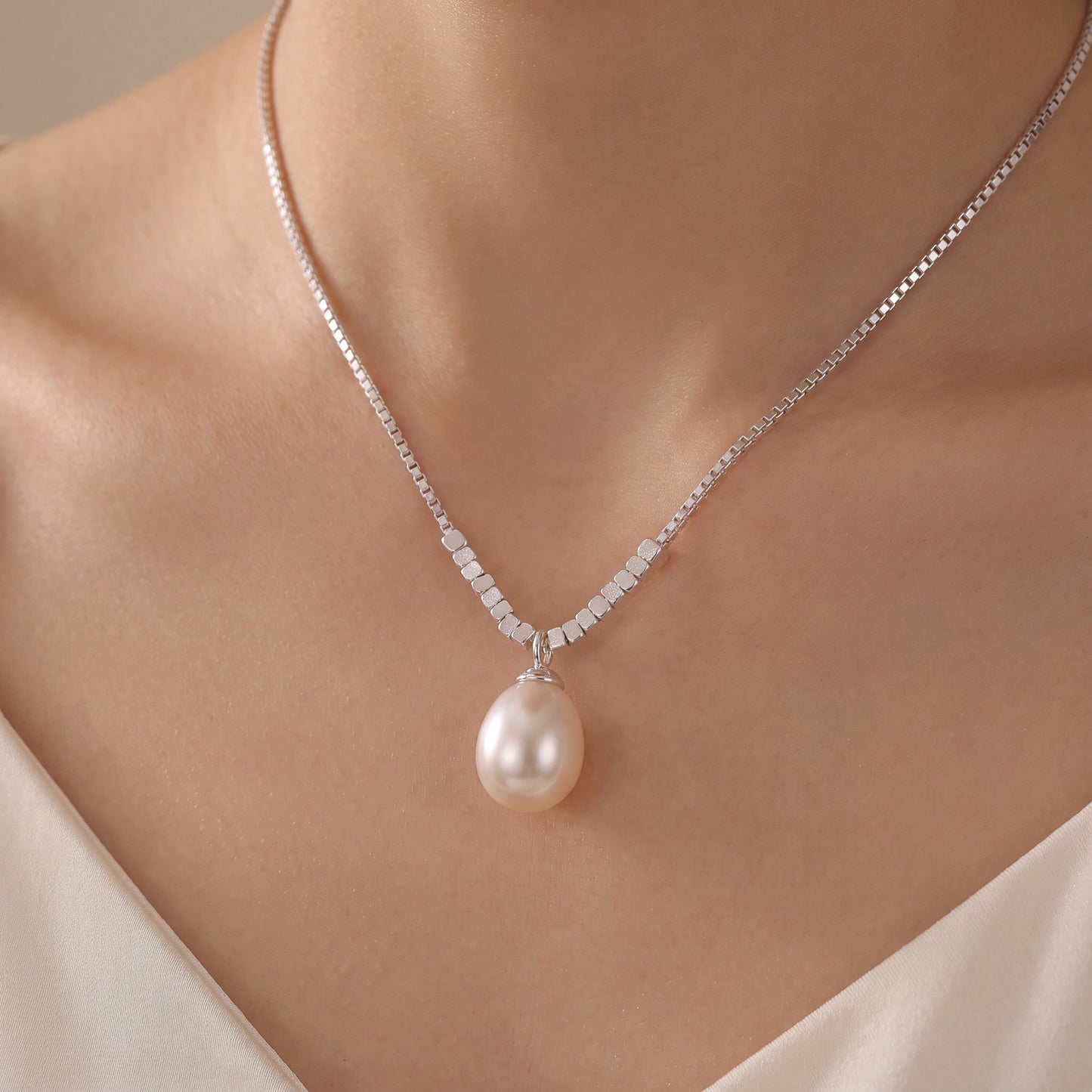 Model wearing photo of 925 sterling silver teardrop pearl pendant necklace