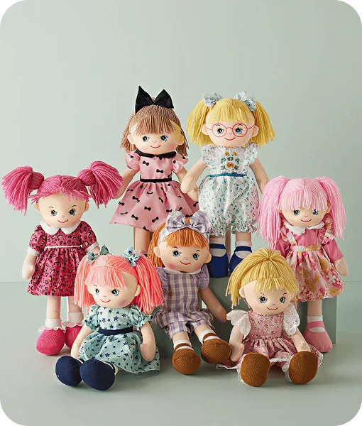 Set of six colorful dolls with different hairstyles and outfits on a light gray background