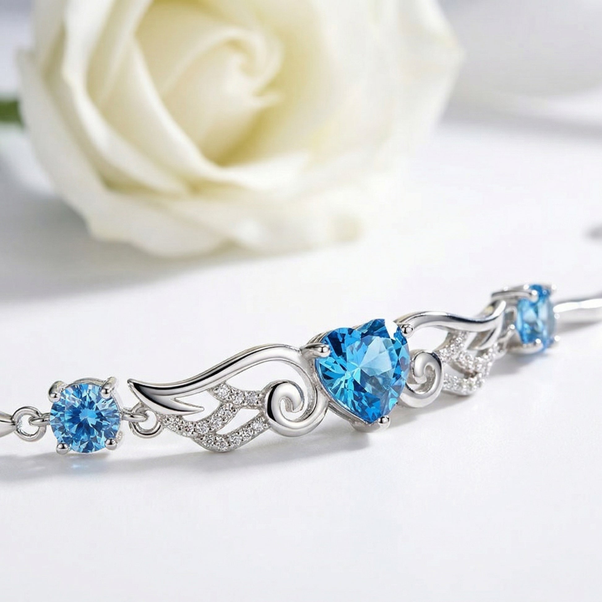Angel Wings 925 sterling silver heart bracelet with sparkling blue heart stone and wing design detail