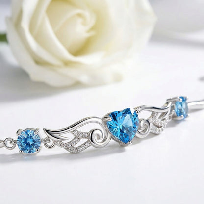 Angel Wings 925 sterling silver heart bracelet with sparkling blue heart stone and wing design detail