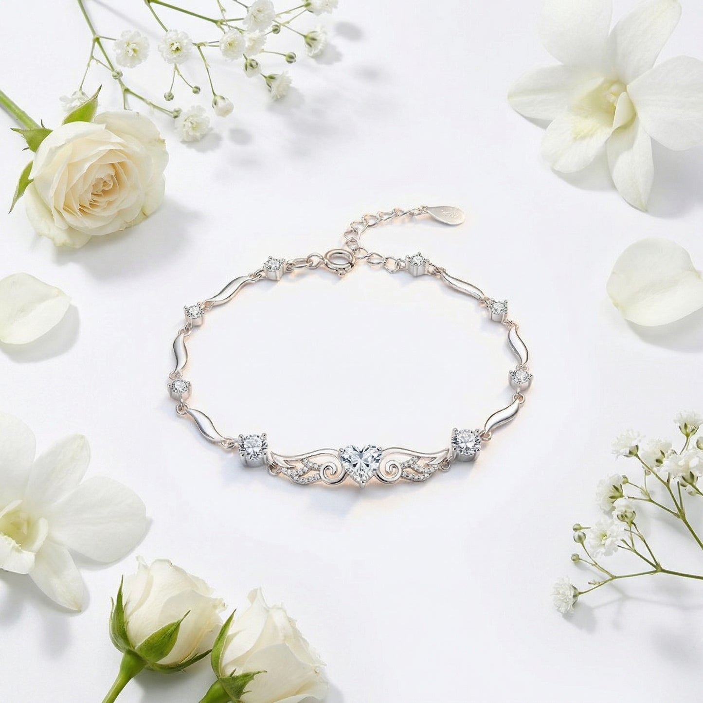 Angel Wings 925 sterling silver heart bracelet with clear crystal heart in elegant flat lay styling
