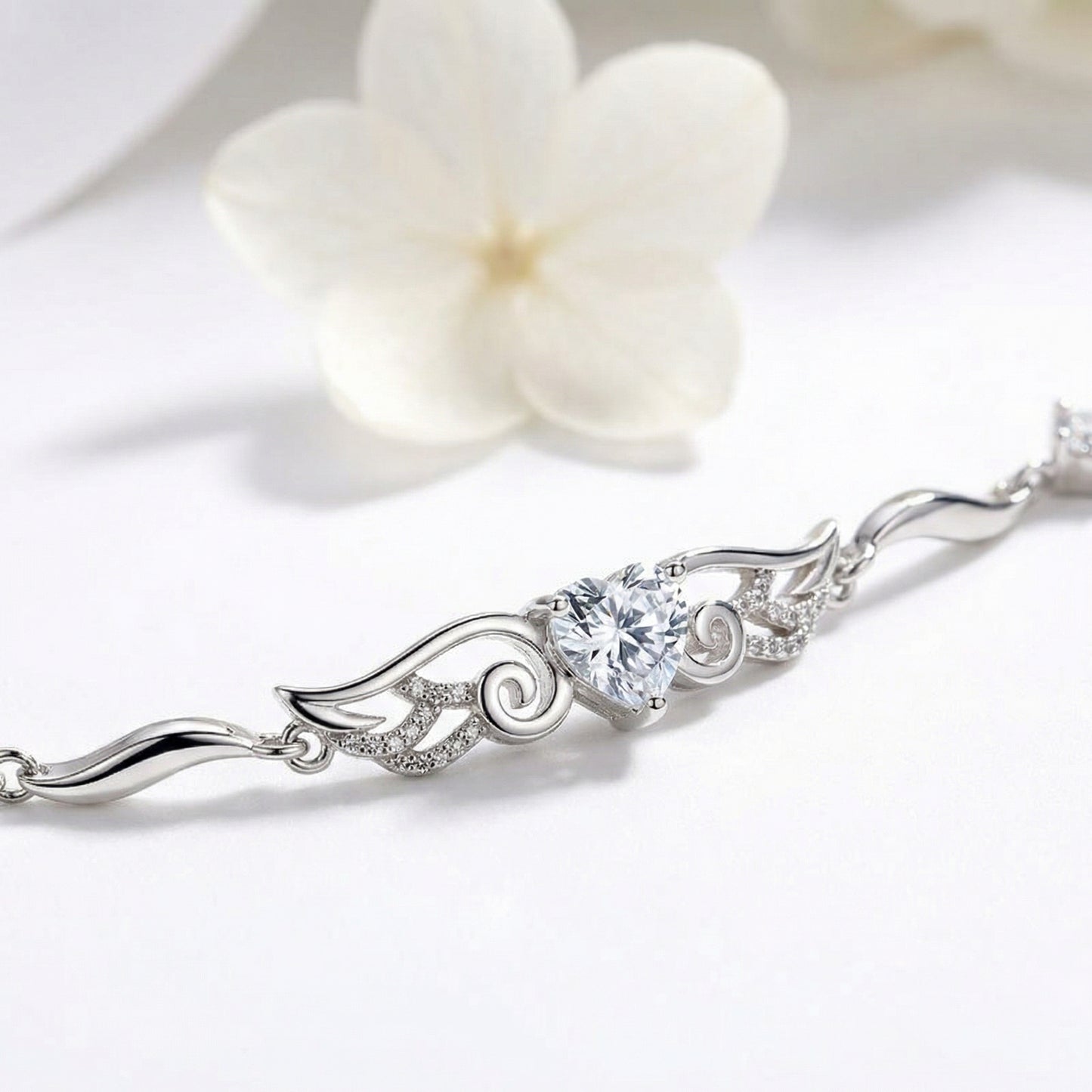 Close up of Angel Wings 925 sterling silver heart bracelet with clear crystal and flowing wing details