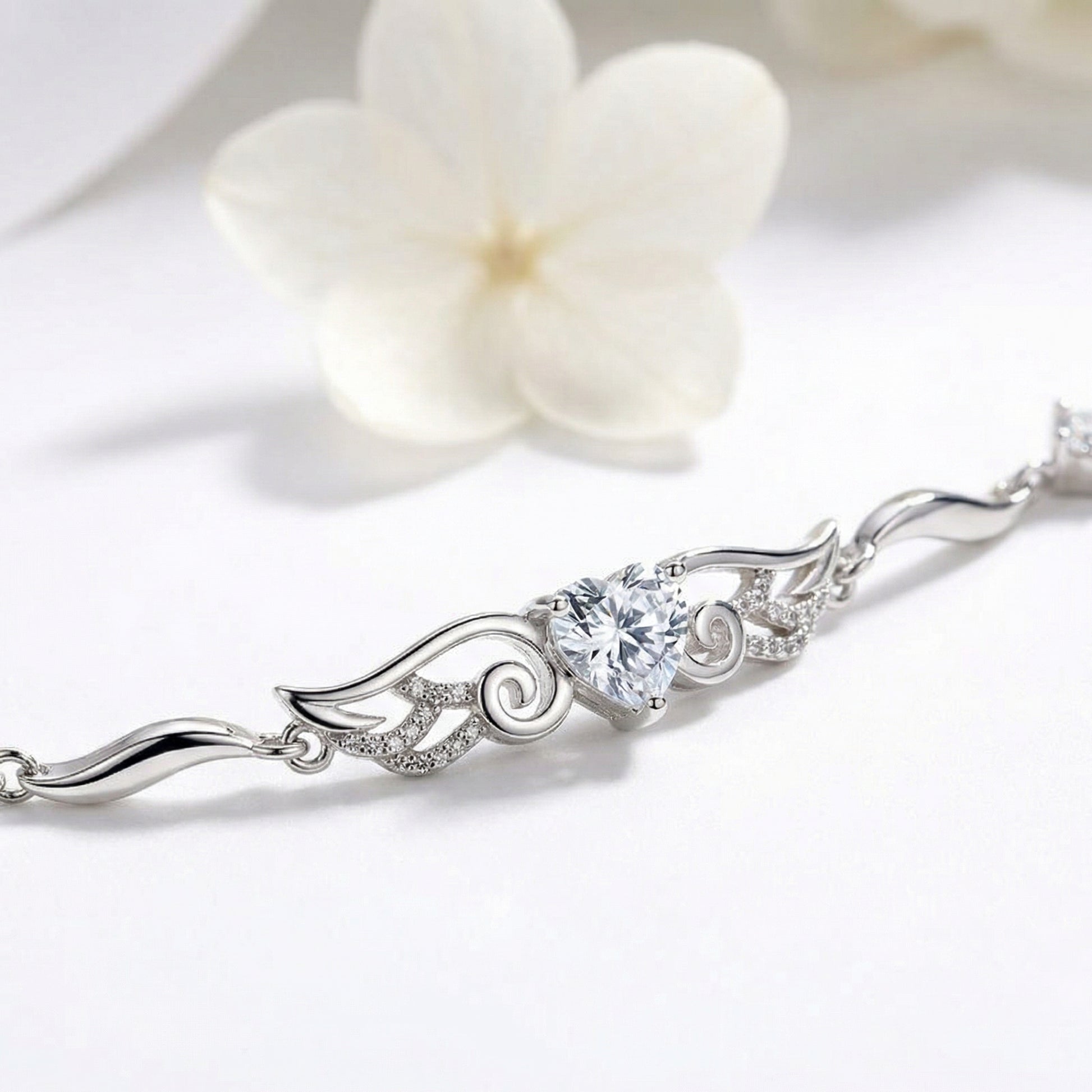 Close up of Angel Wings 925 sterling silver heart bracelet with clear crystal and flowing wing details