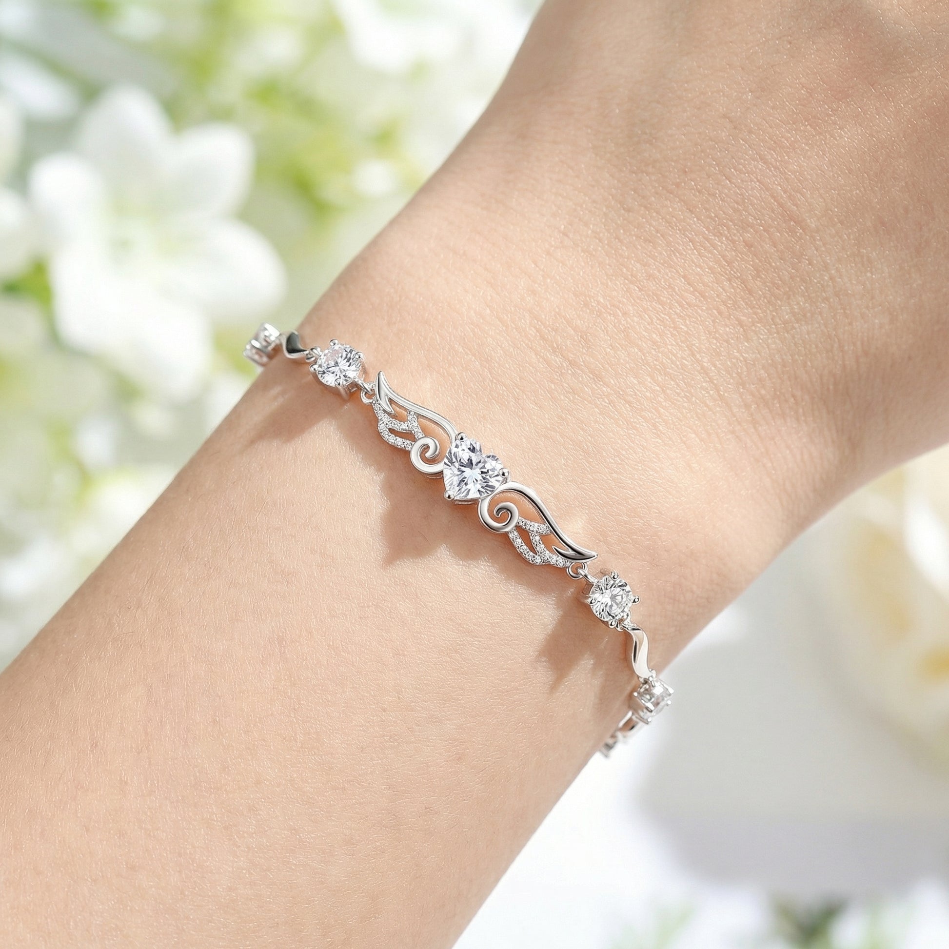 Angel Wings 925 sterling silver heart bracelet worn on wrist with delicate silver wing design