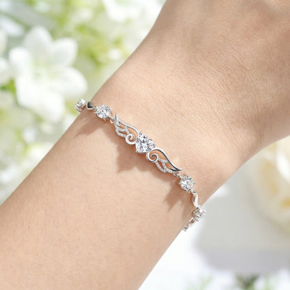 Angel Wings 925 sterling silver heart bracelet worn on wrist with delicate silver wing design