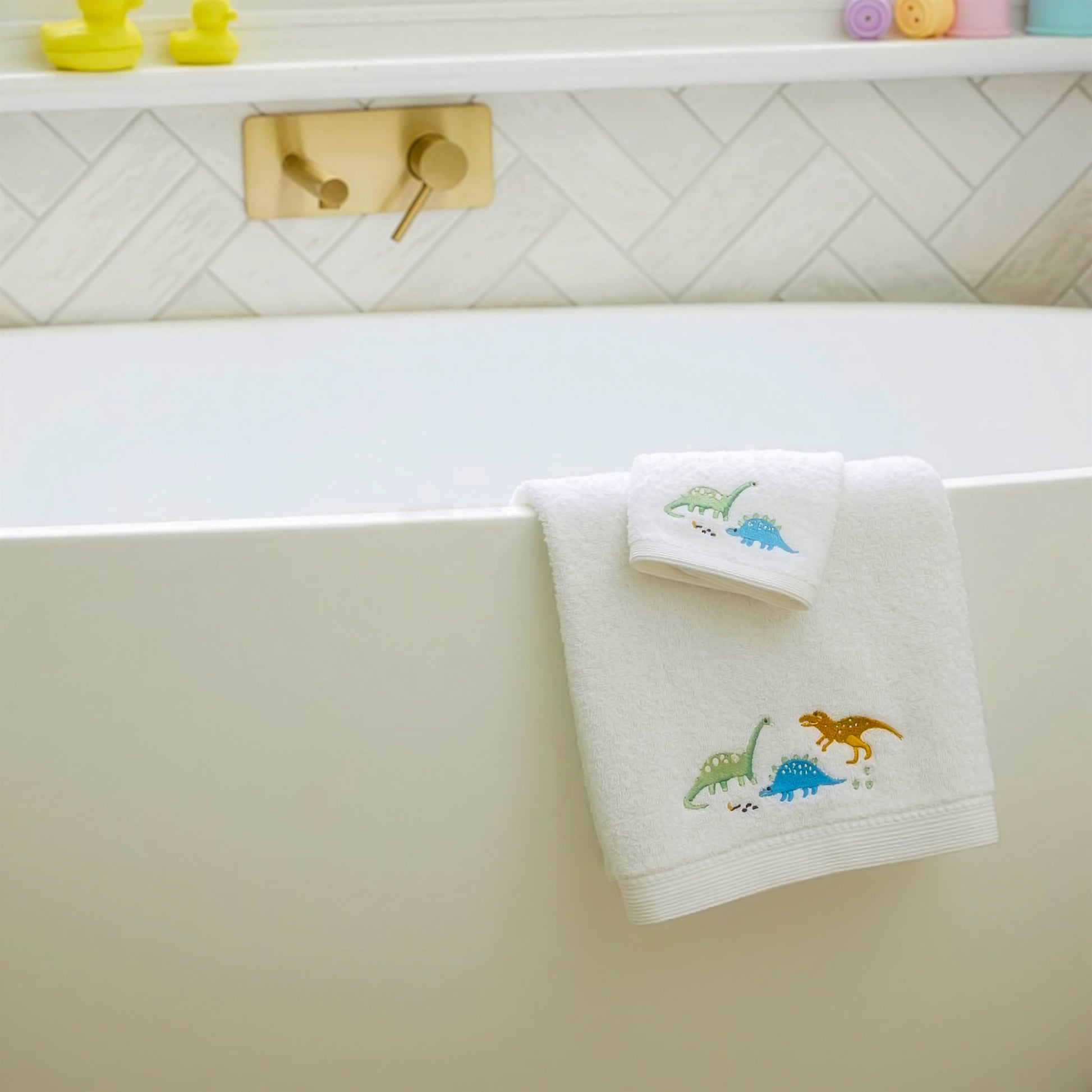 Dinosaur baby bath towel set displayed in modern bathroom