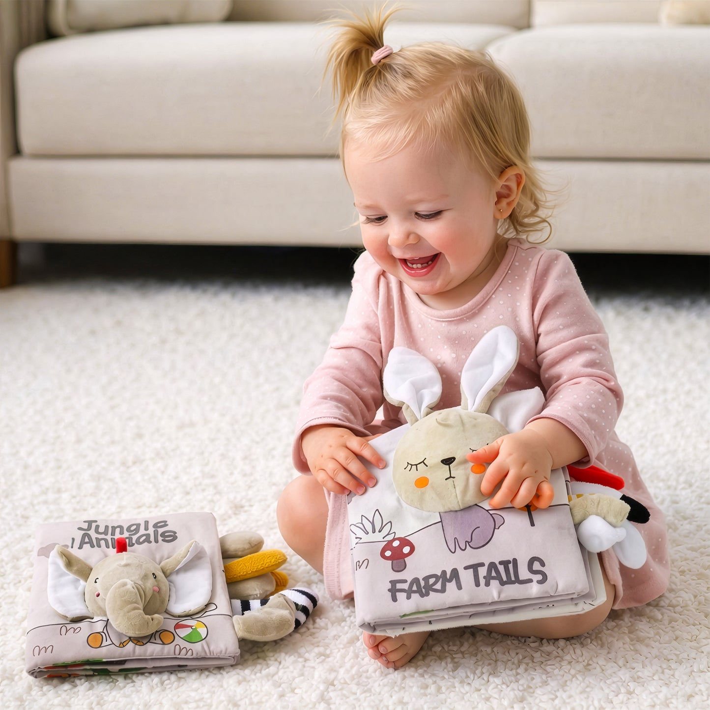 Smiling baby holding Farm Tails sensory soft book