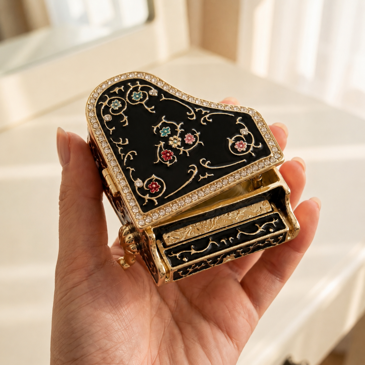 Black floral grand piano jewellery box held in one hand