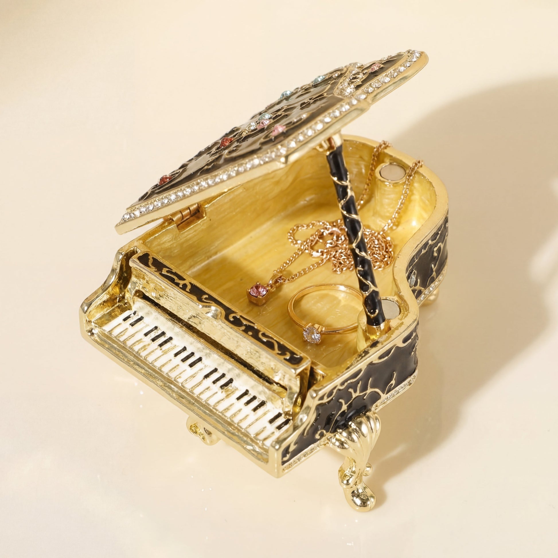 Black piano jewellery box opened with space for rings and small jewellery, a unique gift for her.