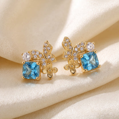 Close-up of blue Gold Butterfly Garden stud earrings with sparkling stones