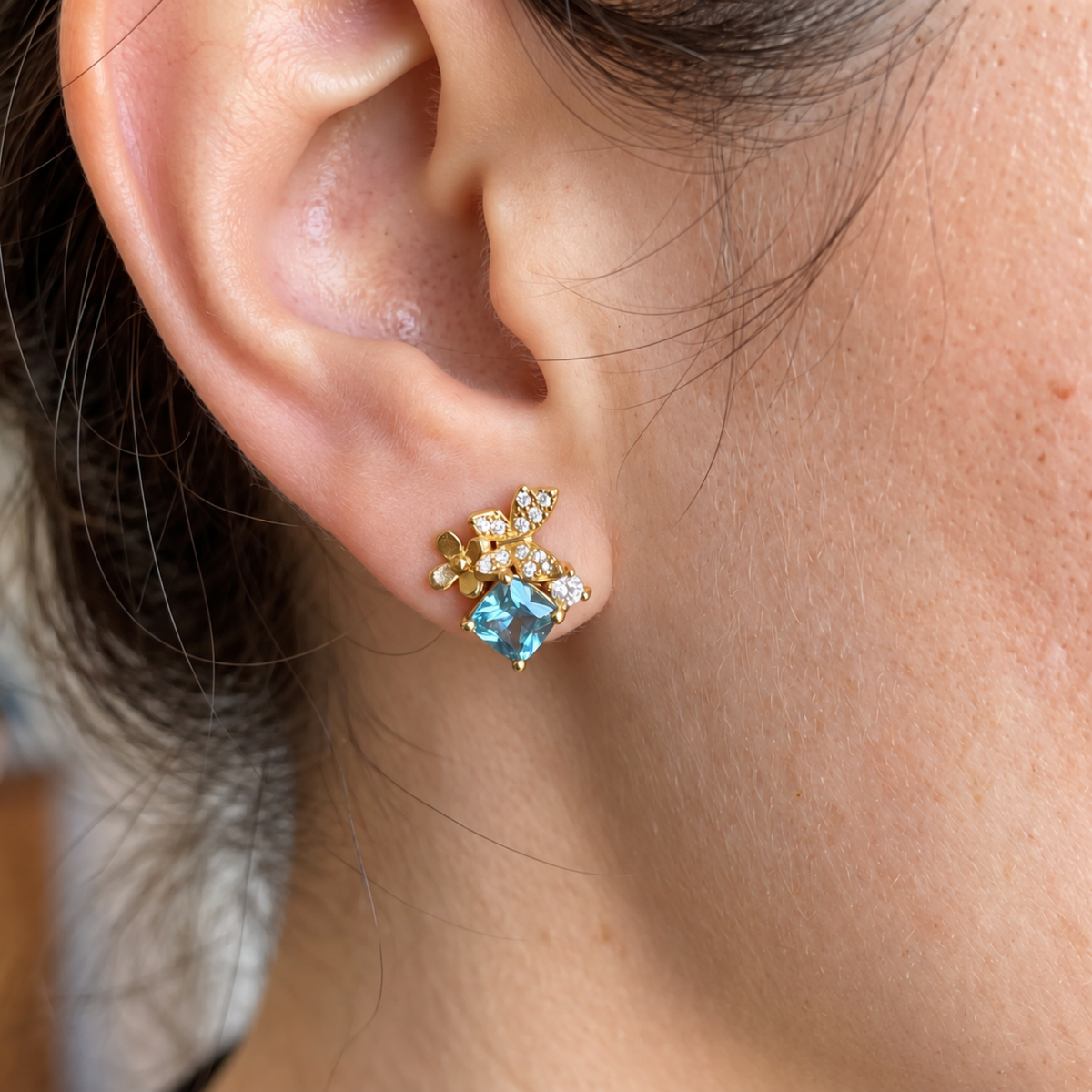 Blue Gold Butterfly Garden sterling silver stud earrings worn on the ear