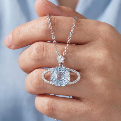 Blue planet sparkling star necklace held by hand showing pendant detail and chain