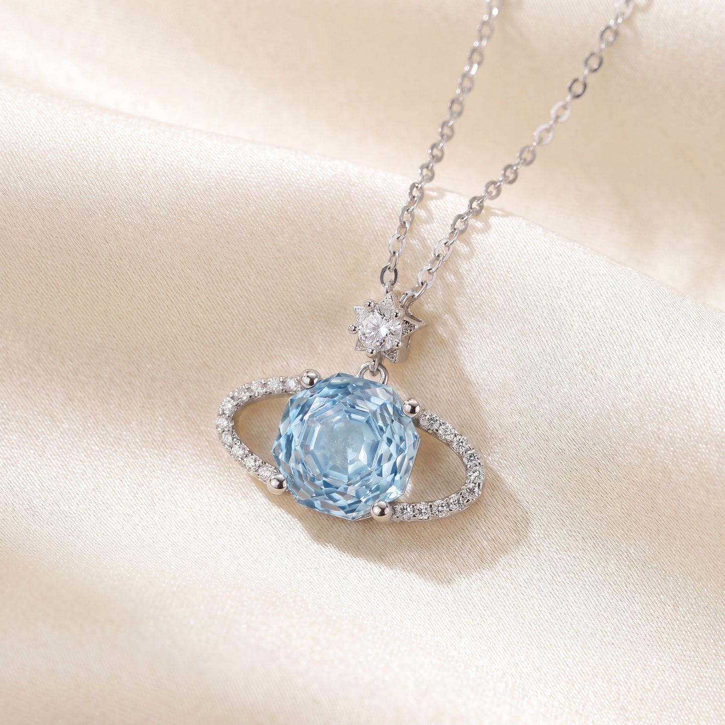 Blue planet sparkling star pendant necklace with light blue stone and polished silver finish