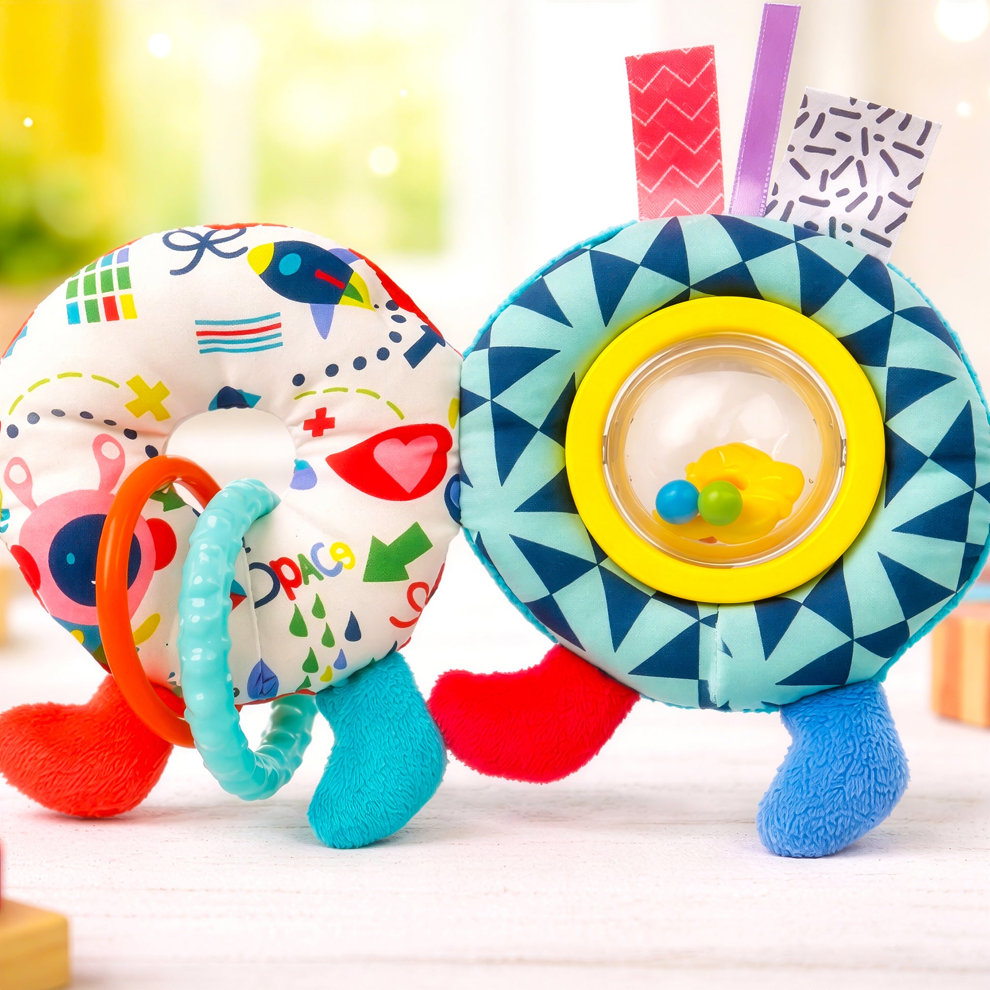 Close up of caterpillar pram chain toy rattle ring and baby mirror sensory detail