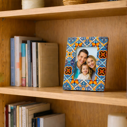 Ceramic photo frame displayed on wooden bookshelf