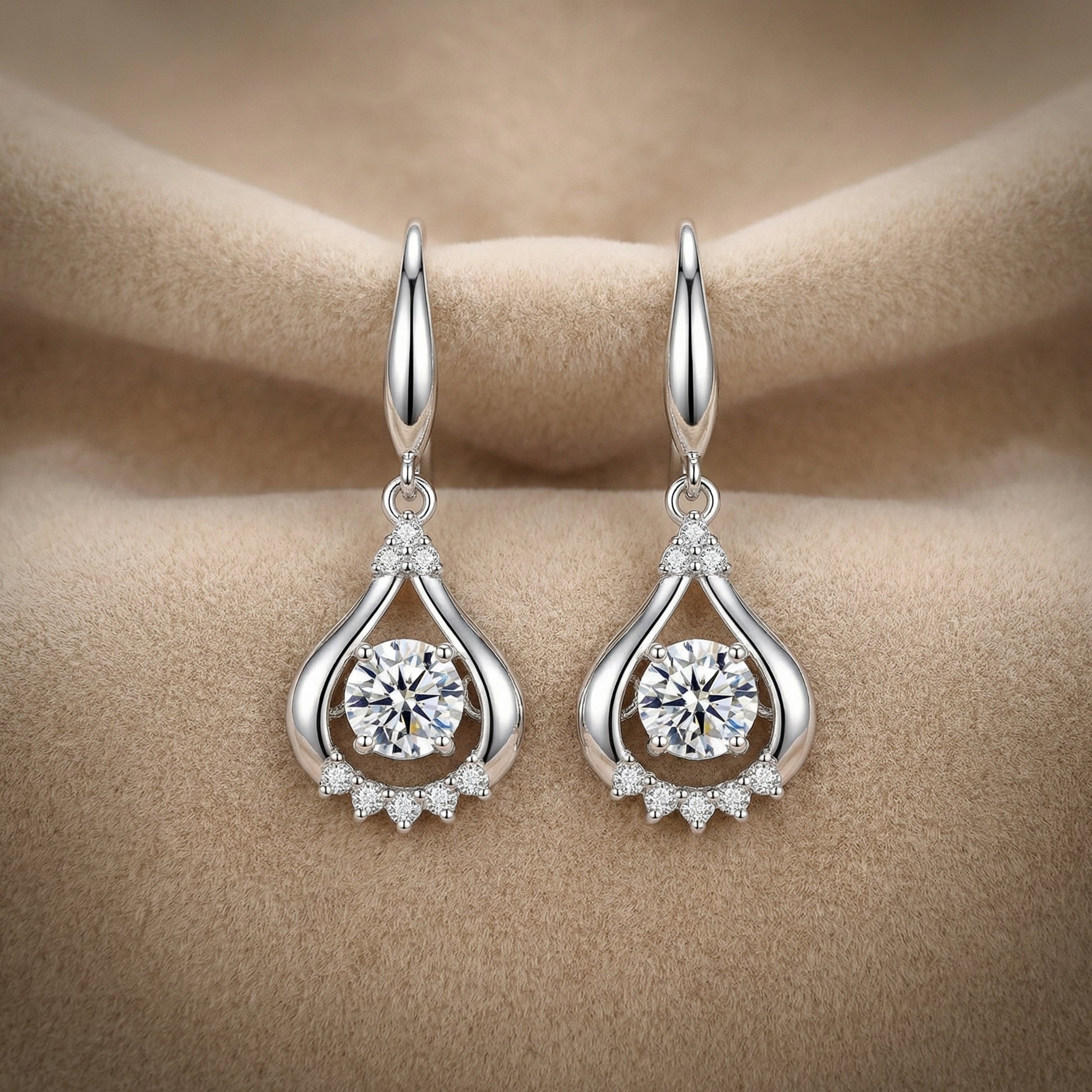 Clear 925 sterling silver teardrop dancing cubic zirconia earrings on soft neutral fabric