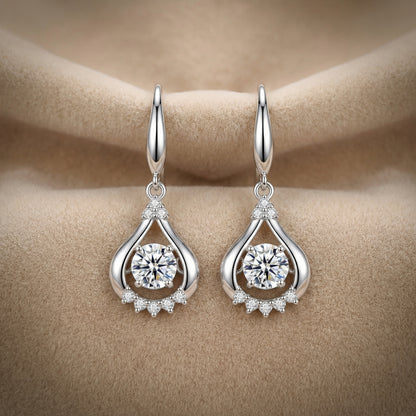 Clear 925 sterling silver teardrop dancing cubic zirconia earrings on soft neutral fabric