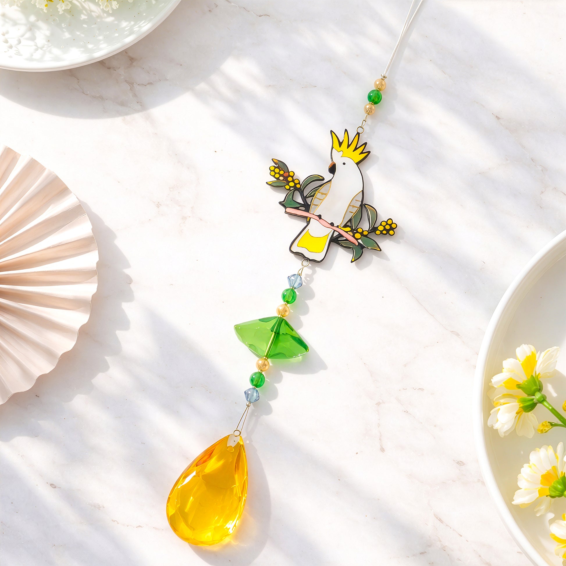 Cockatoo crystal sun catcher detail showing glass pendant, beads and handcrafted design