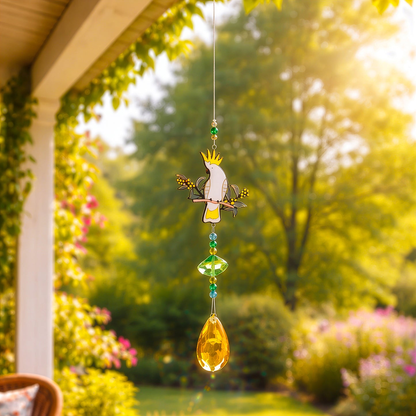 Cockatoo sun catcher hanging on veranda, adding light and colour to outdoor garden space
