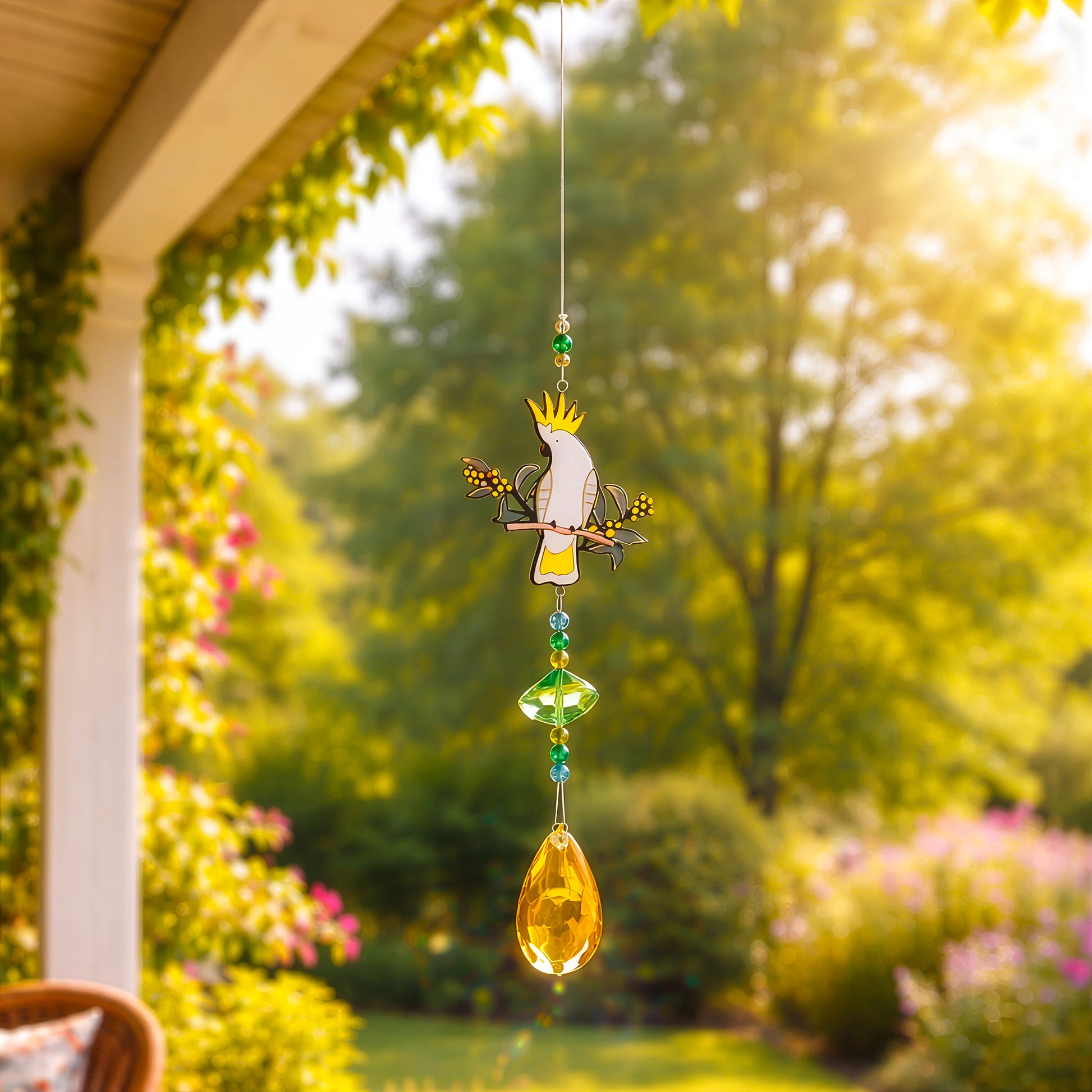 Cockatoo sun catcher hanging on veranda, adding light and colour to outdoor garden space