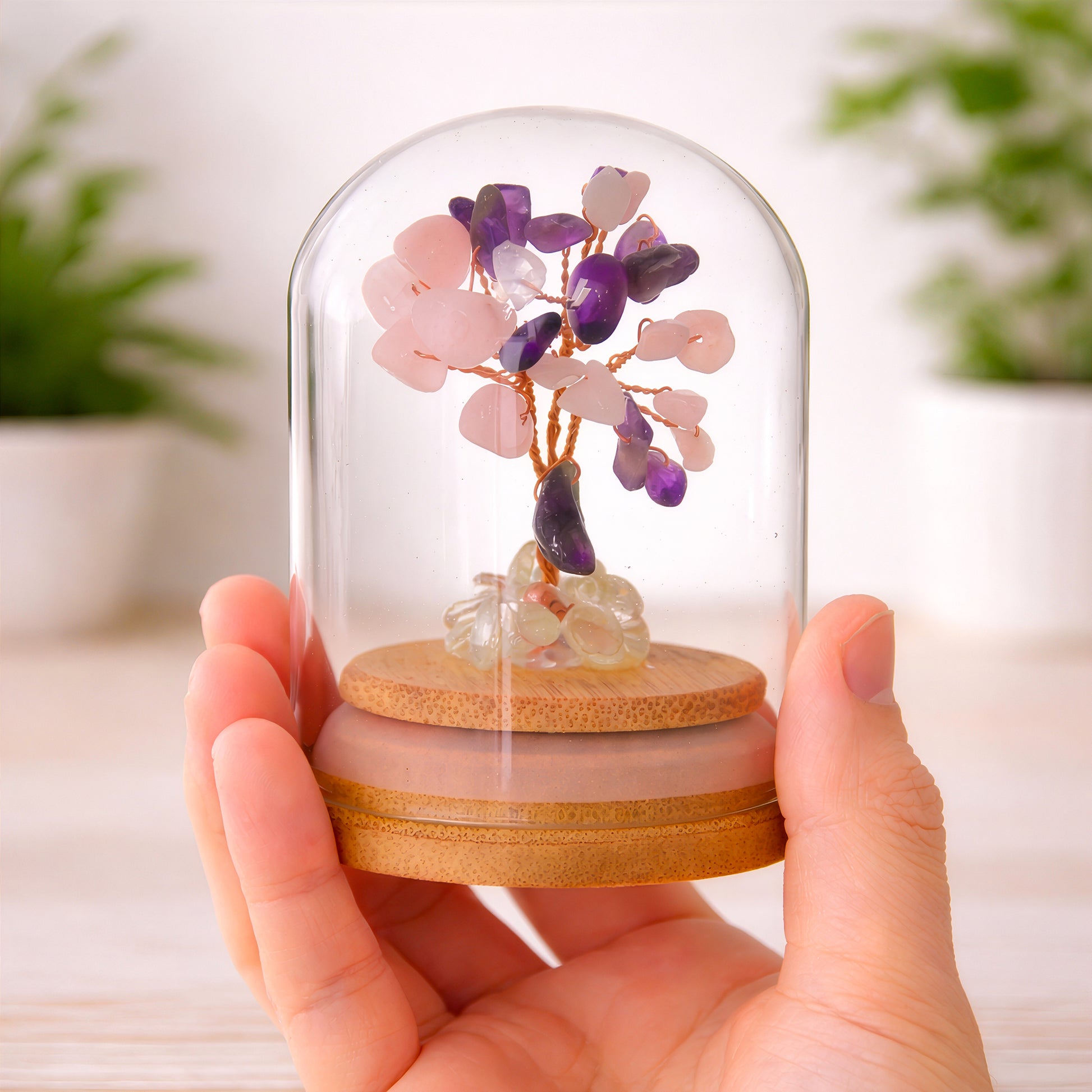 Crystal tree for love and compassion shown in hand to demonstrate size and glass dome detail