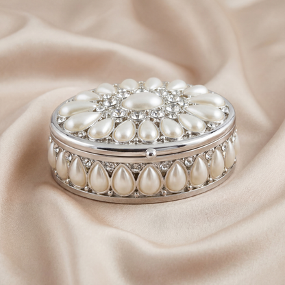 Elegant Pearl Oval Jewellery Box in silver with pearl details on a soft neutral fabric background