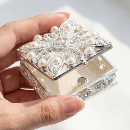 Elegant Pearl Square Jewellery Box held in hand to show its compact size and delicate design