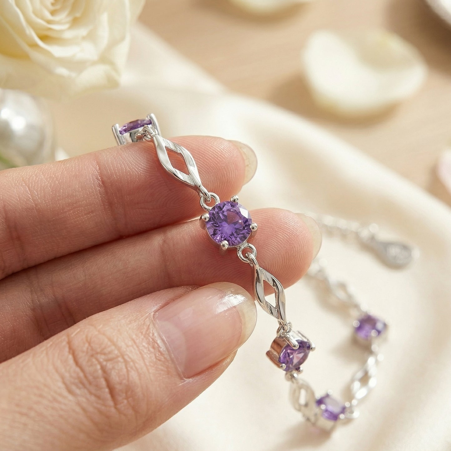 Close up of purple cubic zirconia 999 fine silver bracelet with elegant twisted chain design