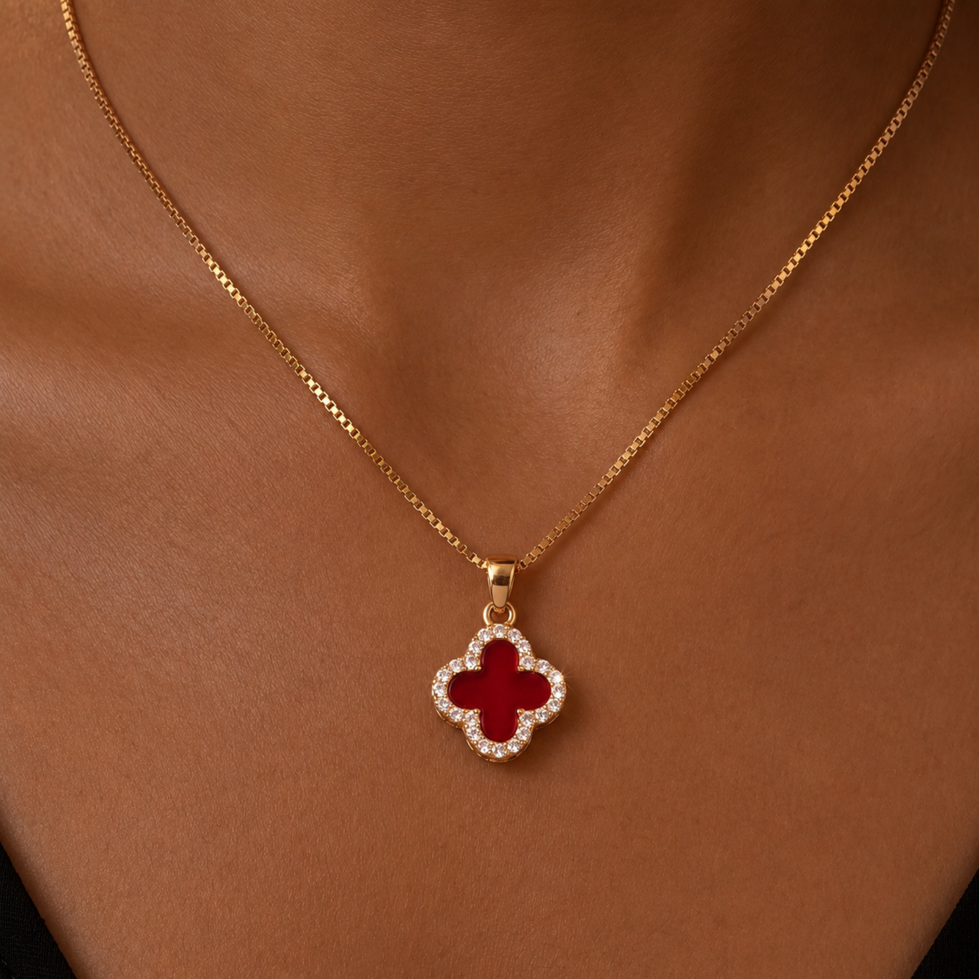 red four leaf clover pendant necklace with gold chain worn by model