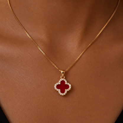 red four leaf clover pendant necklace with gold chain worn by model