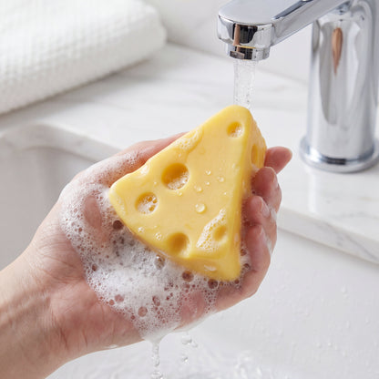 Cheese shaped silk protein cleansing soap being used with foamy bubbles in hand