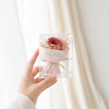 Hand holding a classic red dried rose bouquet box, gift-ready preserved flower present for her