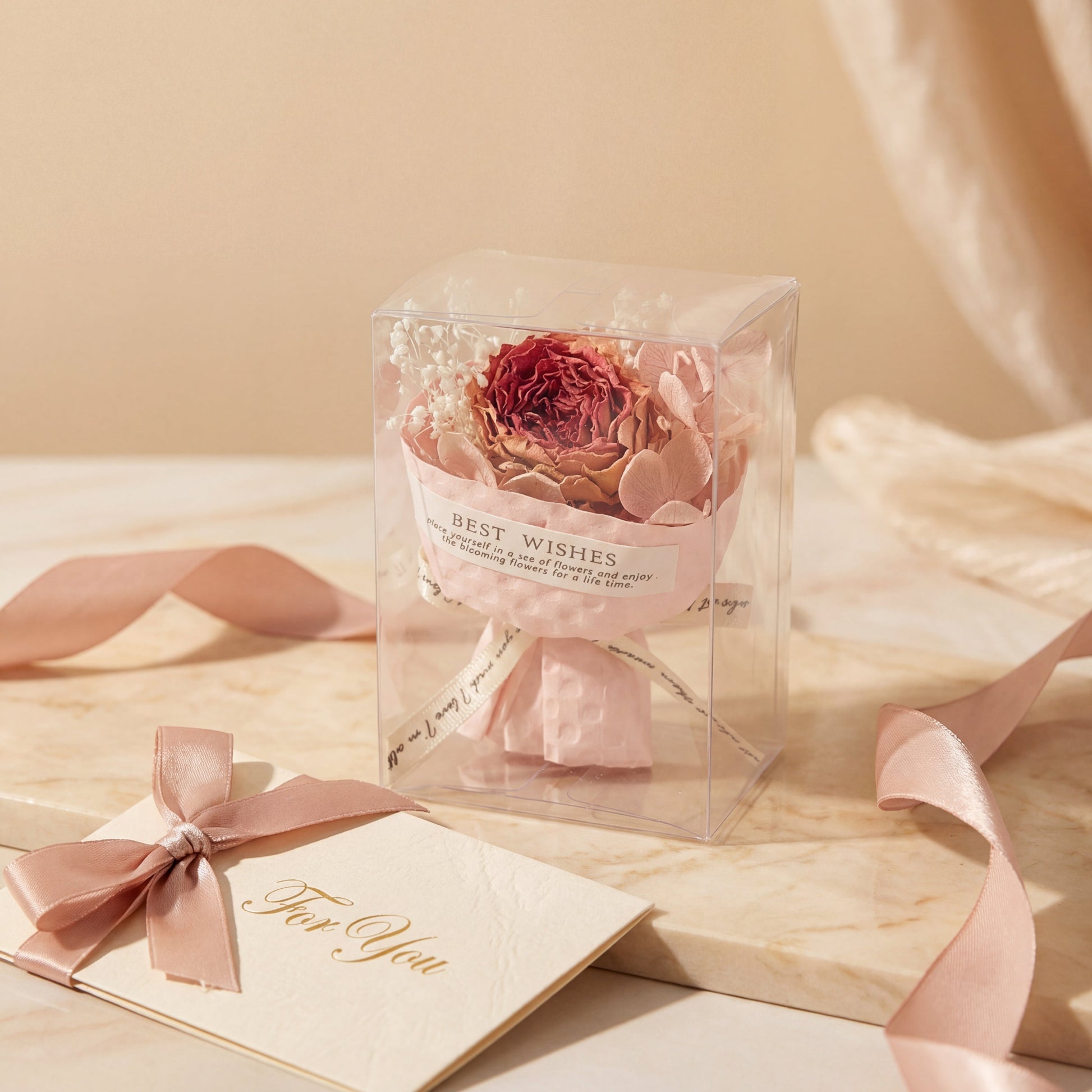 Classic red dried flower bouquet box on soft fabric with envelope, thoughtful gift-ready present for her