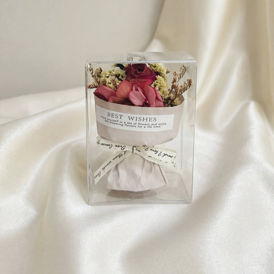 Red rose dried flower bouquet box on white silk fabric, romantic gift-ready flower box