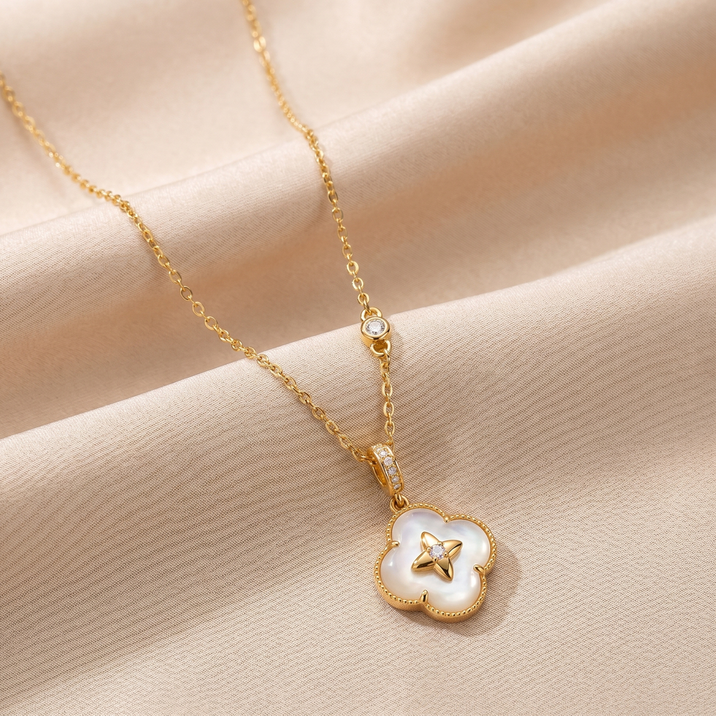 Gold lucky clover 925 sterling silver necklace arranged on champagne satin