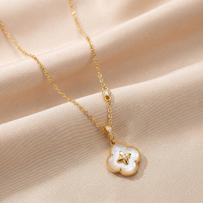 Gold lucky clover 925 sterling silver necklace arranged on champagne satin