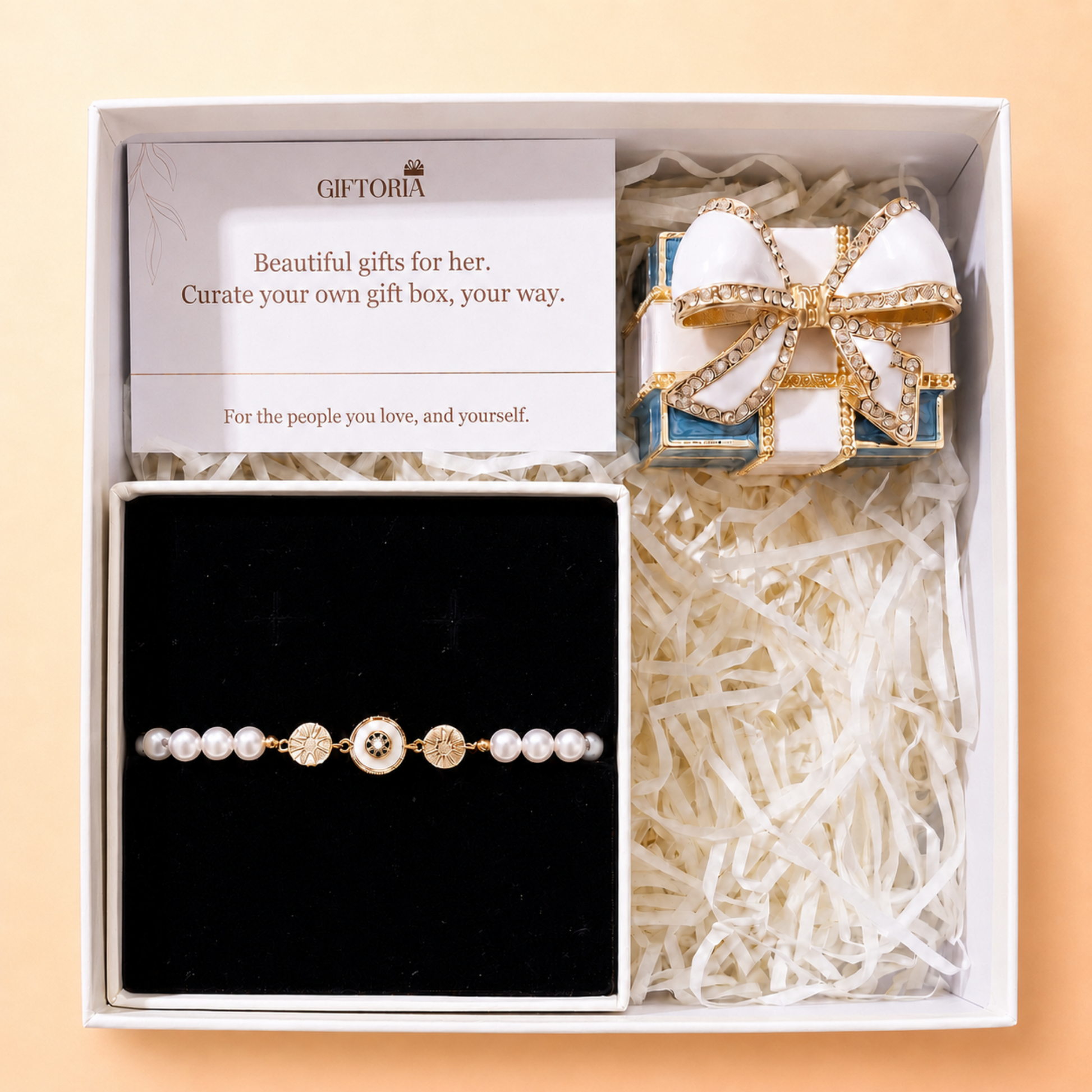 Gold evil eye pearl bracelet and vintage bow jewellery box presented in a Giftoria gift set