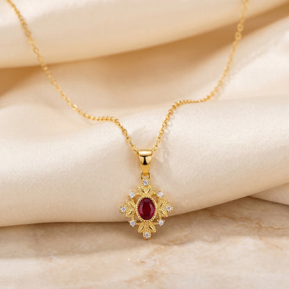 Full view of a gold 925 sterling silver ruby red vintage pendant necklace on soft ivory fabric