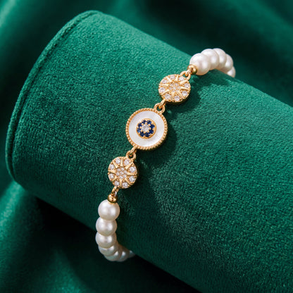 Gold Sunburst Evil Eye Pearl Bracelet with pearl beads and vintage gold details